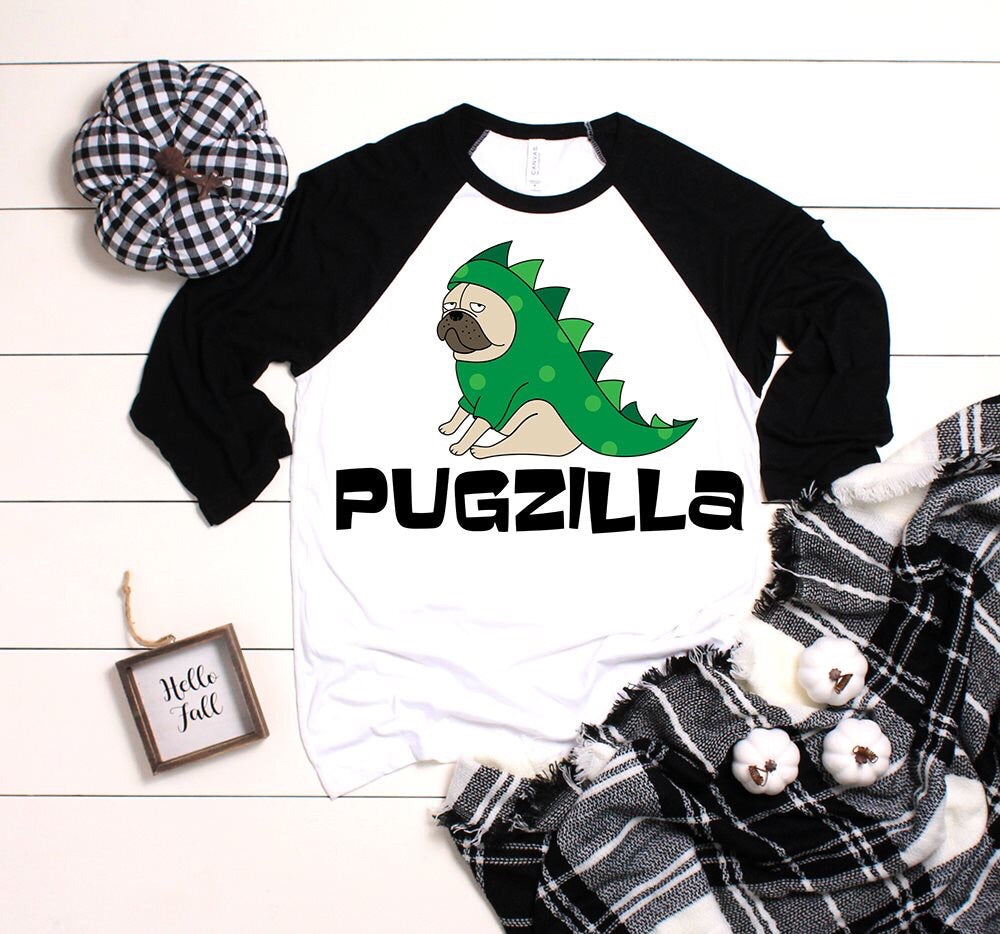 pug in a godzilla suit and pugzilla written on a shirt