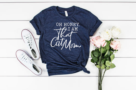 Bella tee in Navy Heather with the words "Oh honey, I am that cat mom" in stylized white text.