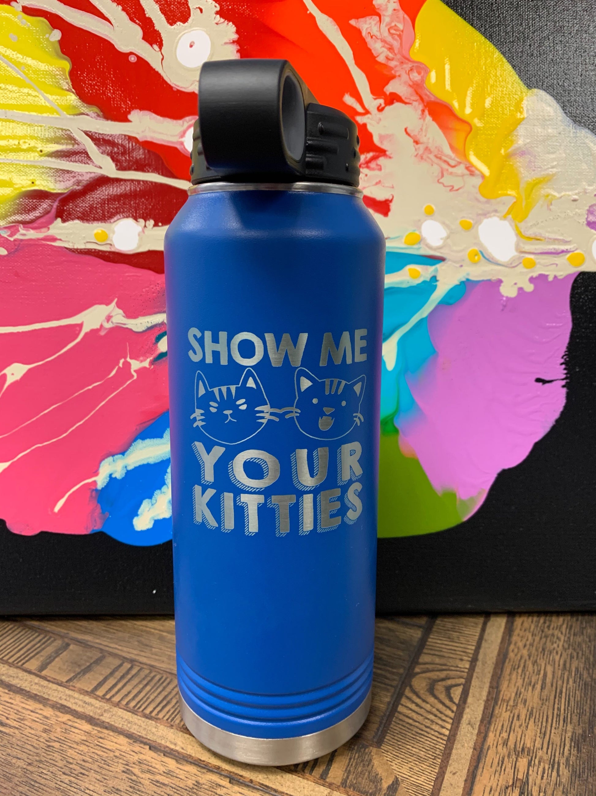 Image of an insulated tumbler bottle in Royal with black plastic screw-on lid, featuring two cat faces, and the words "show me your kitties" laser etched in the side of the bottle.